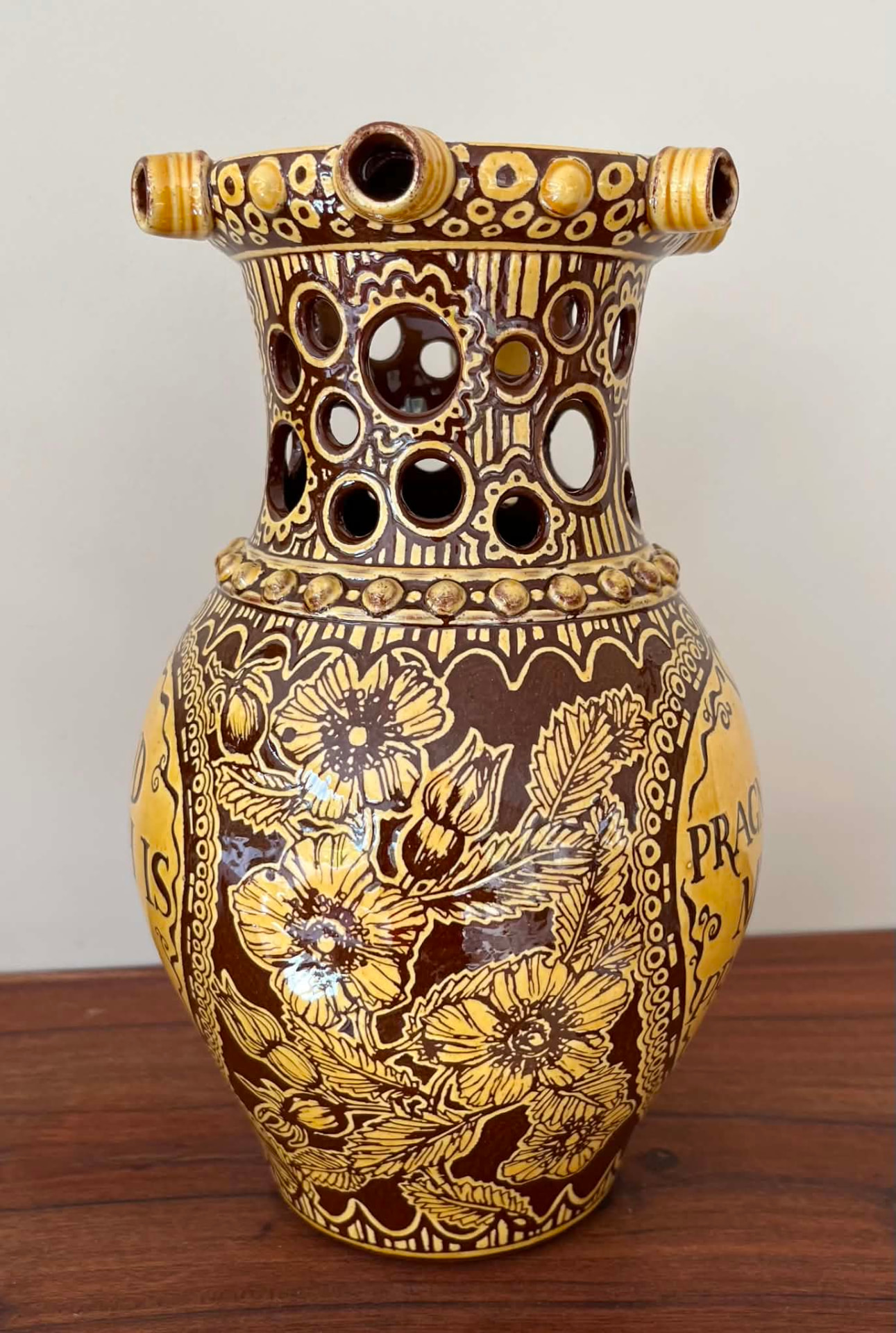 Finished floral panel carved around the body of the puzzle jug.