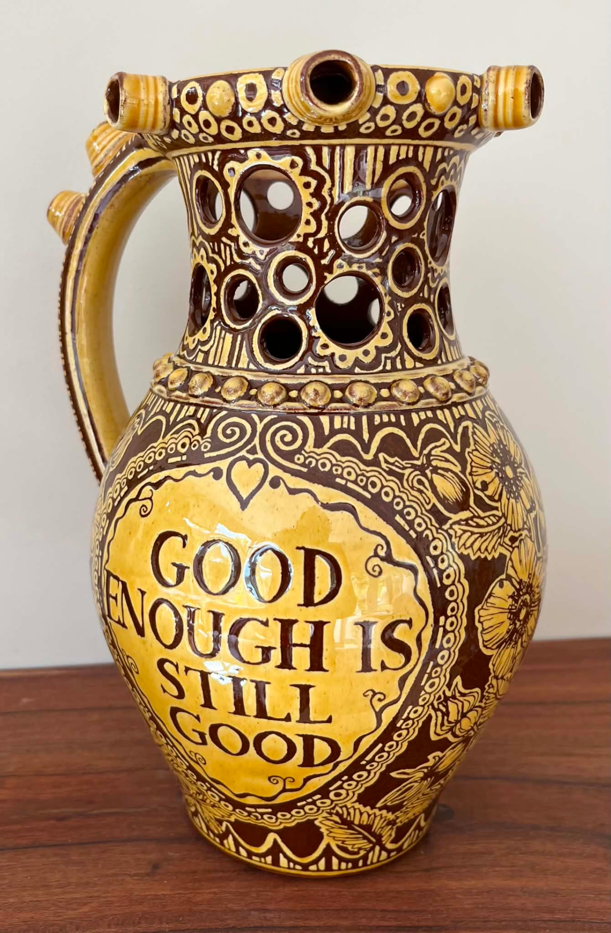 Finished side of the puzzle jug inscribed Good enough is still good.